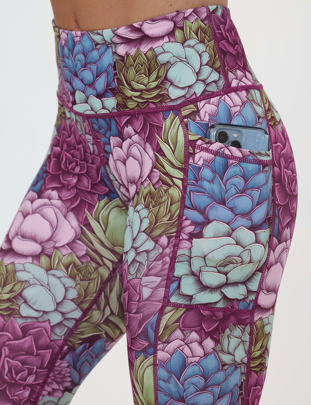 close up of the succulent flowers leggings pocket holding a phone