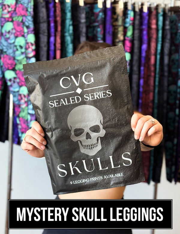 front of the CVG Sealed Series: Skulls Bag featuring a blacked out design with a grey skull in the middle, 9 leggings prints are available