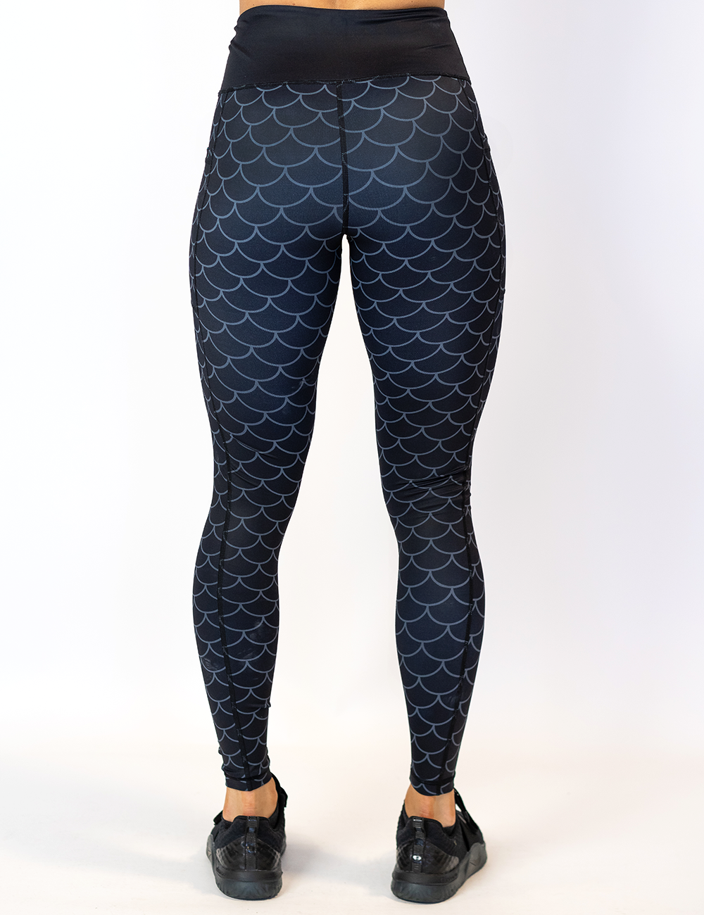 back of the dragon scale outline against a dark background pattern full length leggings against a white background