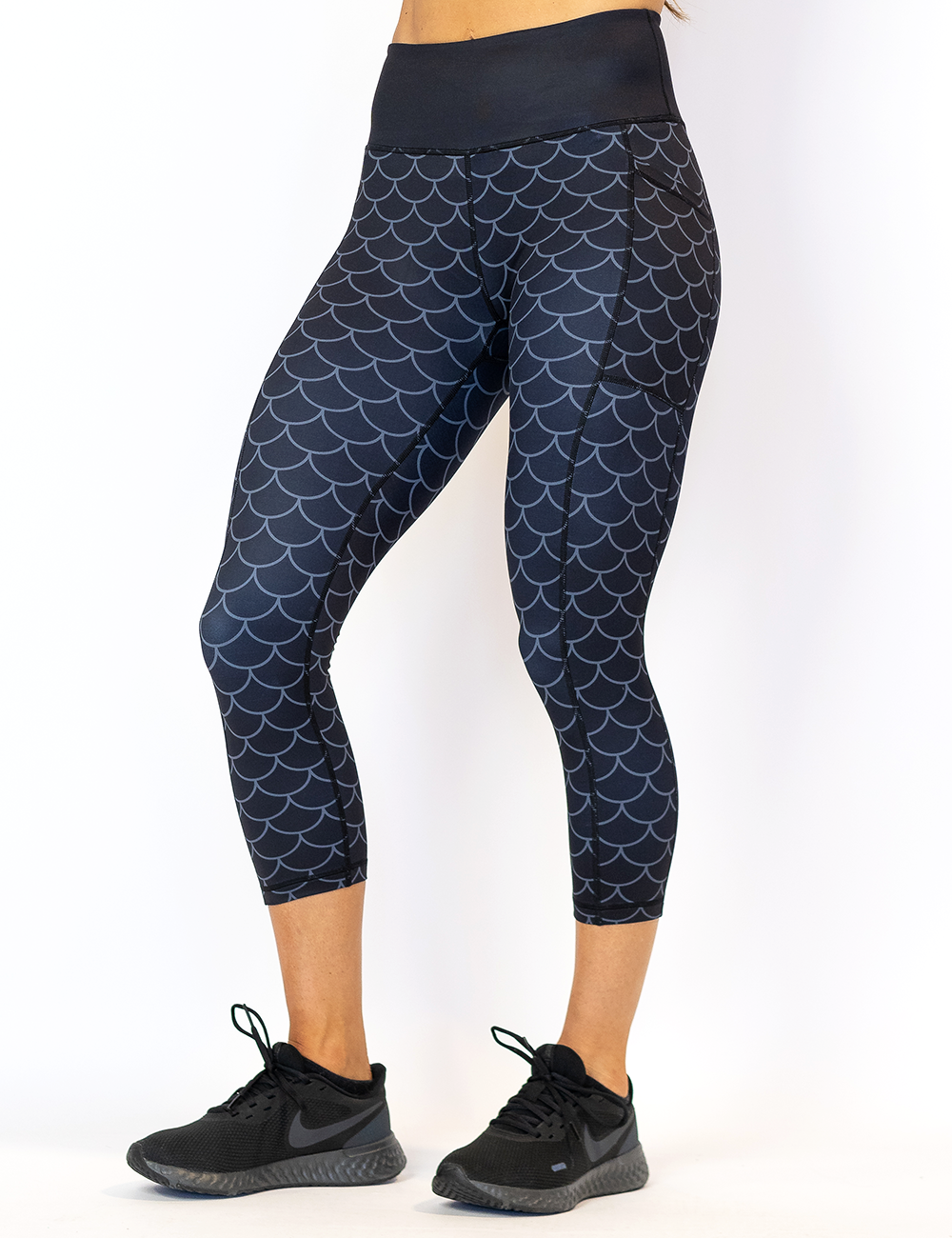 dragon scale outline against a dark background pattern capri leggings facing the front against a white background