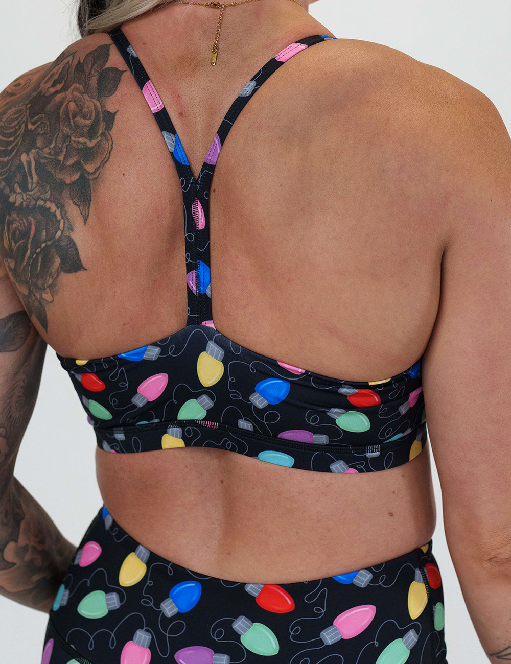 back of the Christmas lights patterned sports bra