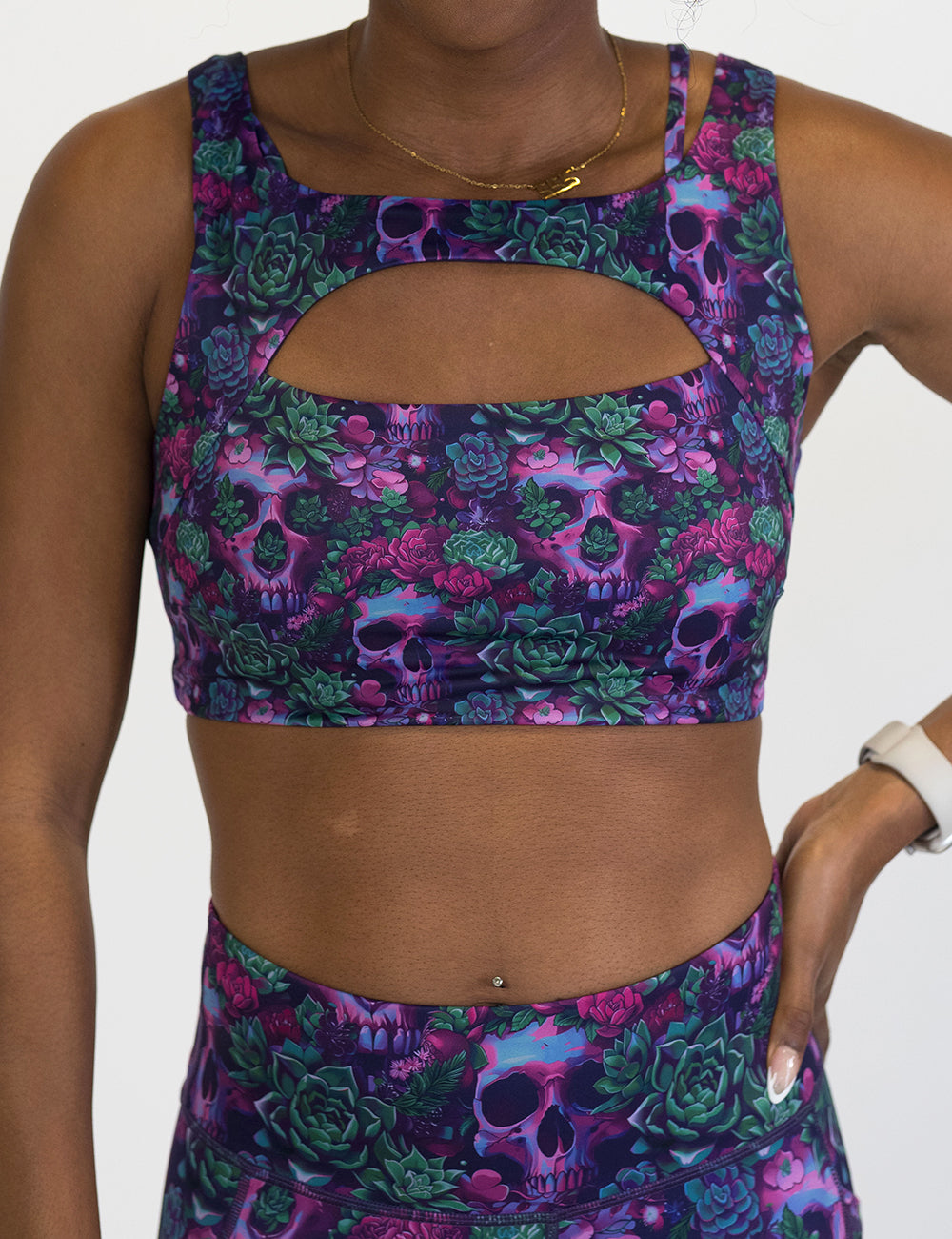 front of the floral and skull patterned sports bra