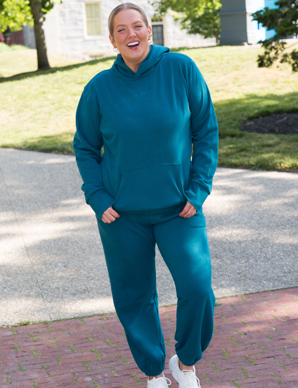 model wearing teal sweatsuit
