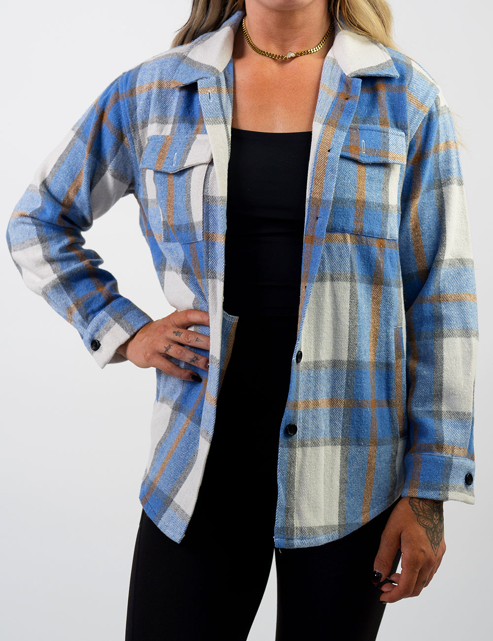 front of the light blue, white, grey, and gold shacket against a white background