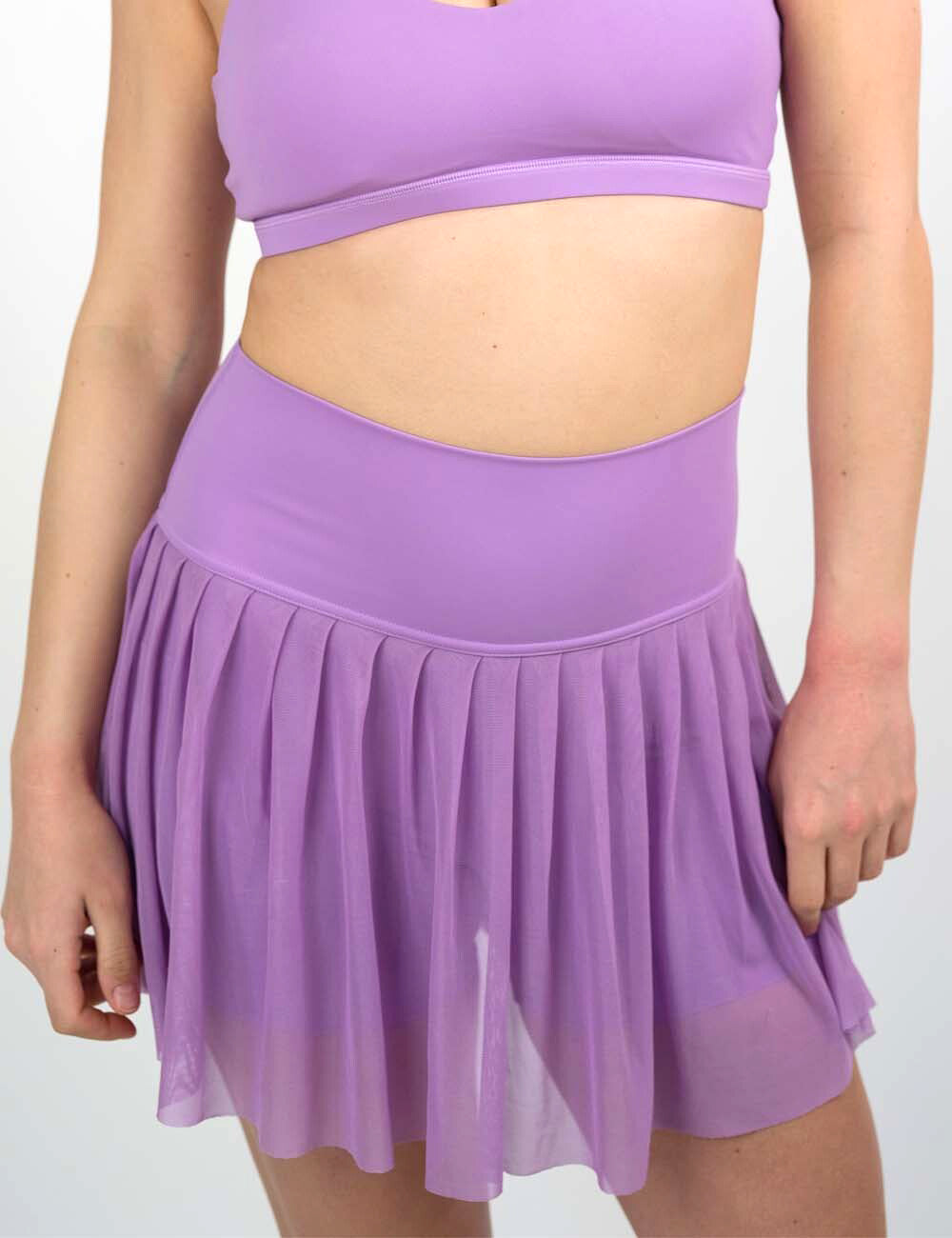 front of the sheer purple skirt against a white background