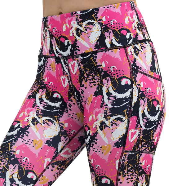 close up of the white hearts against a bold pink, black, and yellow pattern leggings against a white background
