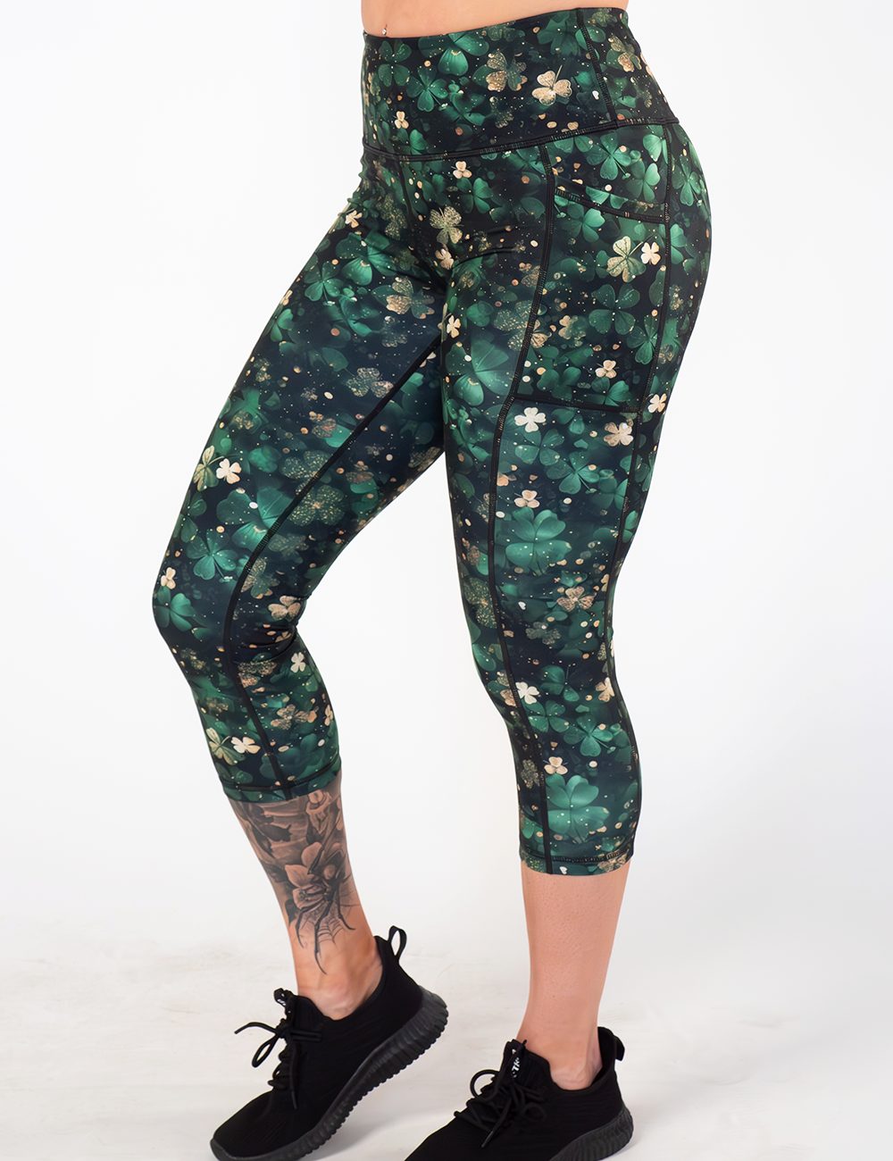 model wearing the green and gold clover lucky capri leggings against a white background
