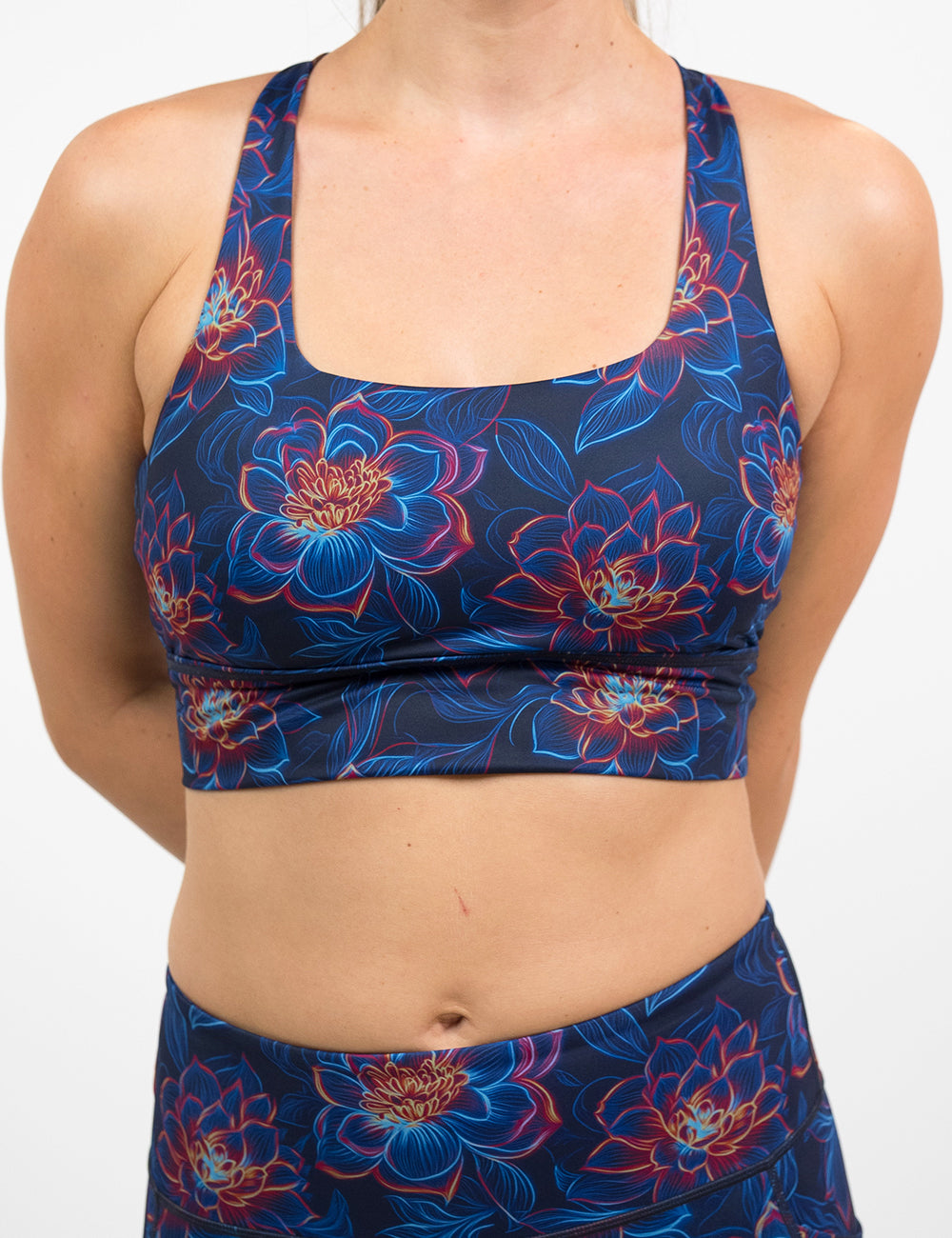 front of the neon flower print bra against a white background
