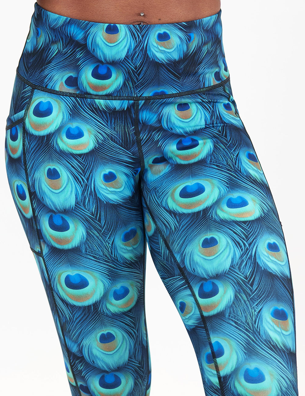 front of the peacock print leggings against a white background