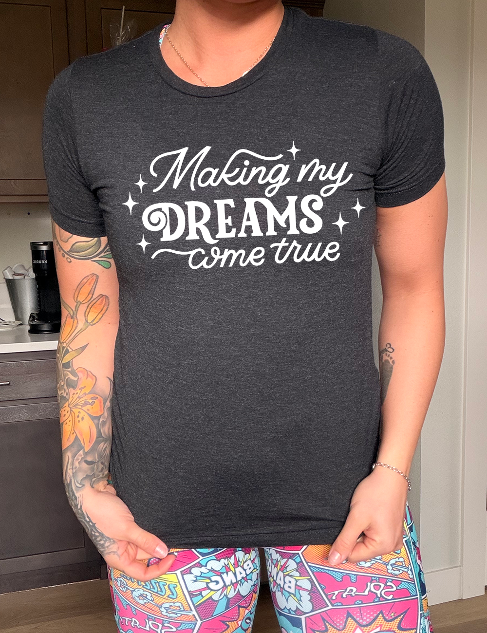 black unisex tee with the words "making my dreams come true" on it, with a few little stars around it