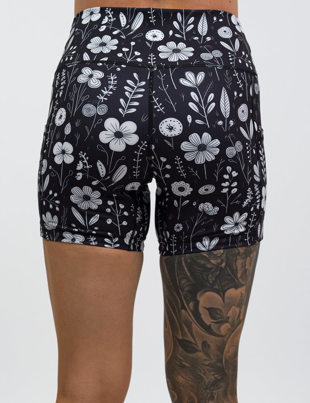 back of the 5 inch black and white floral shorts against a white background