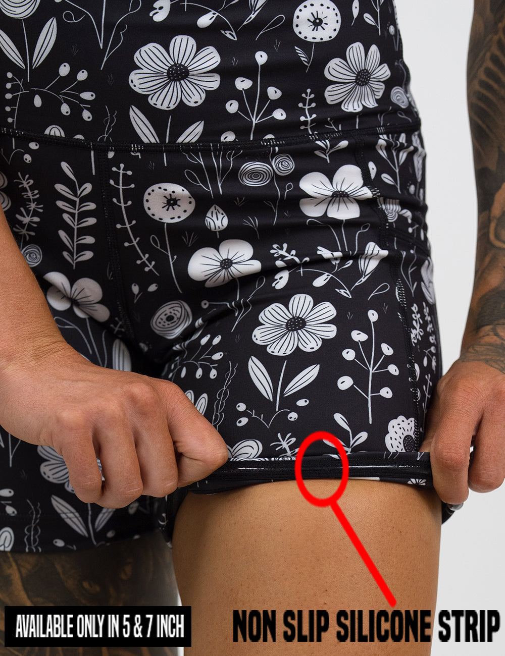 close up of the black and white floral shorts rolled up to show the non slip silicone strip found in the lining of the 5 and 7 inch shorts