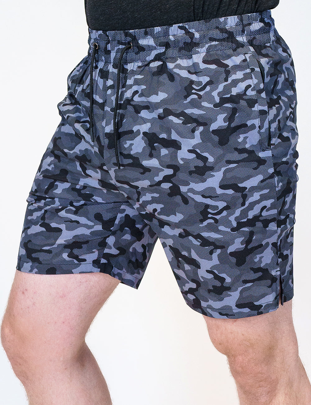 front view of black and grey camo quarter length unisex shorts