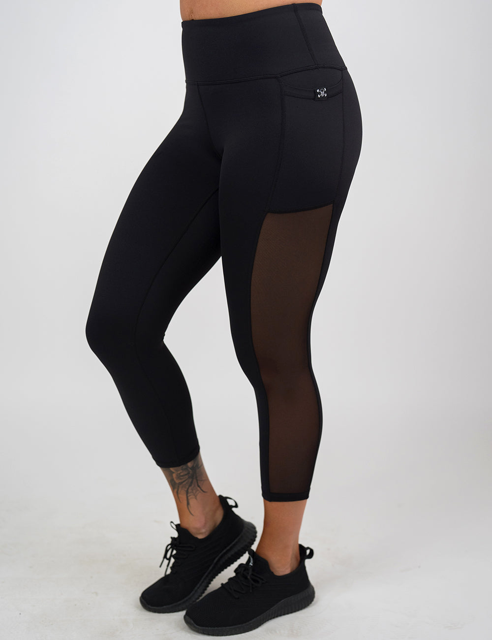 front of the capri black mesh leggings against a white background