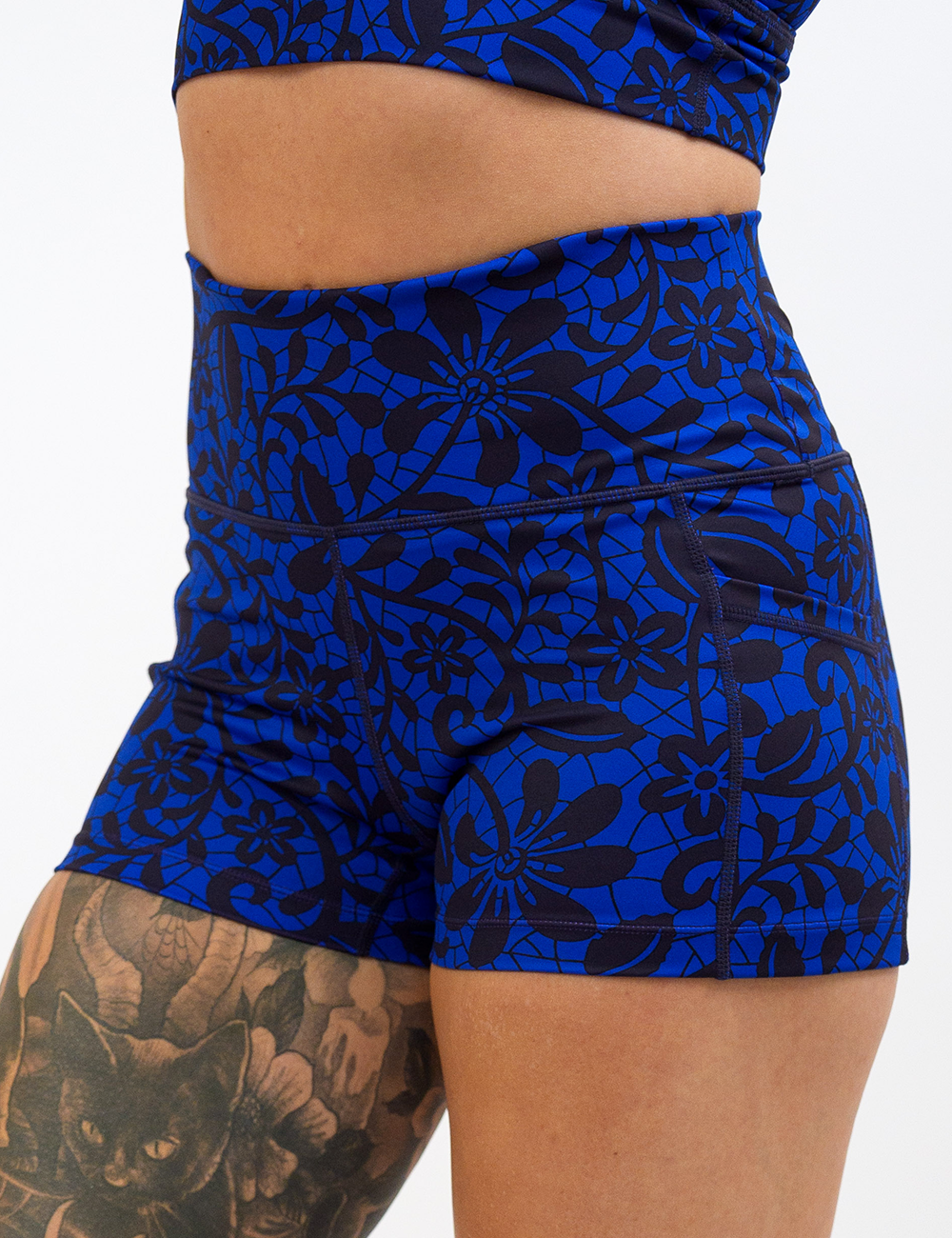close up of the black floral against a dark blue background 2.5 inch shorts against a white background