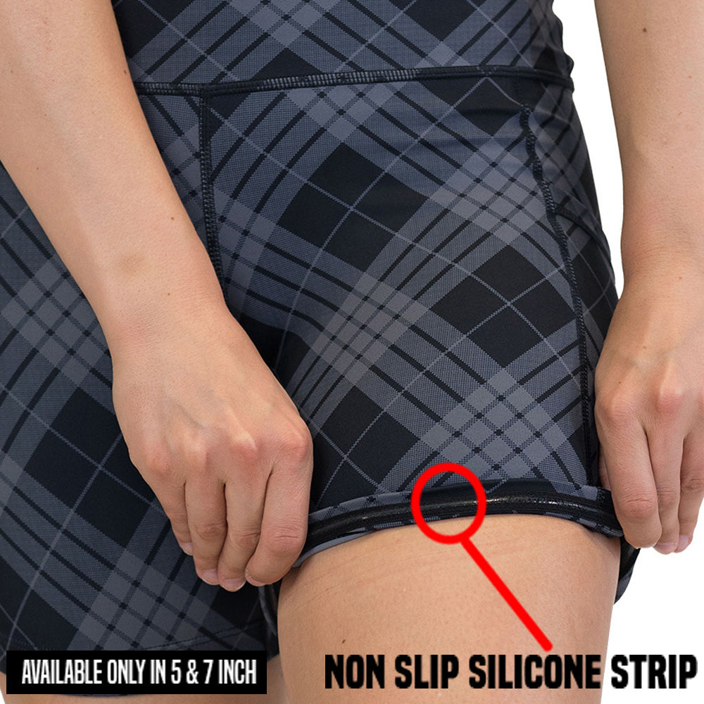 Person wearing black and gray checkered shorts with a non-slip silicone strip highlighted.