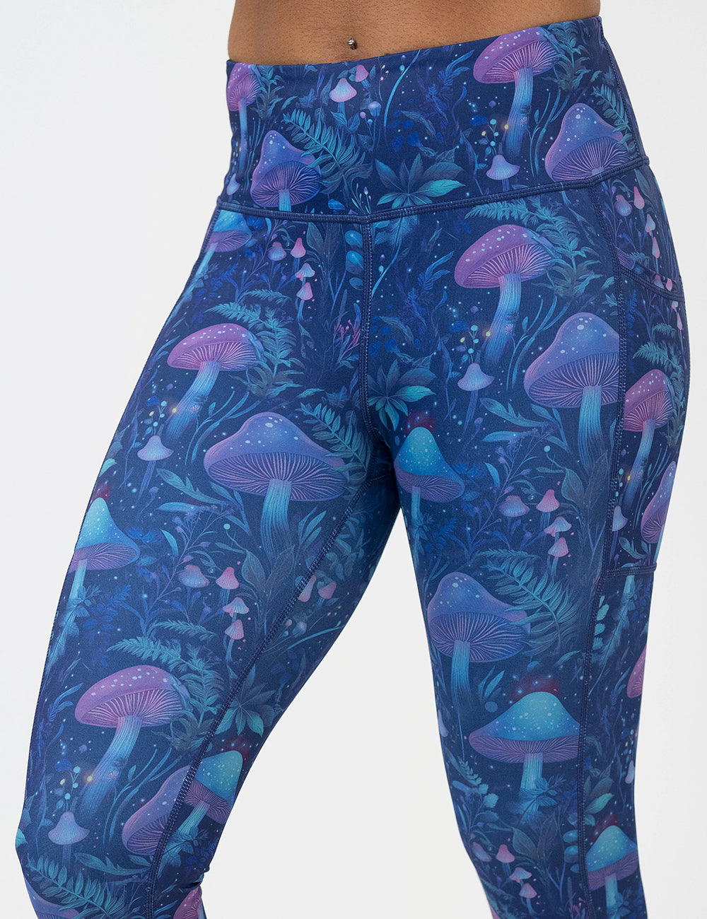 leggings with a blue and purple mushroom and foliage design on a white background