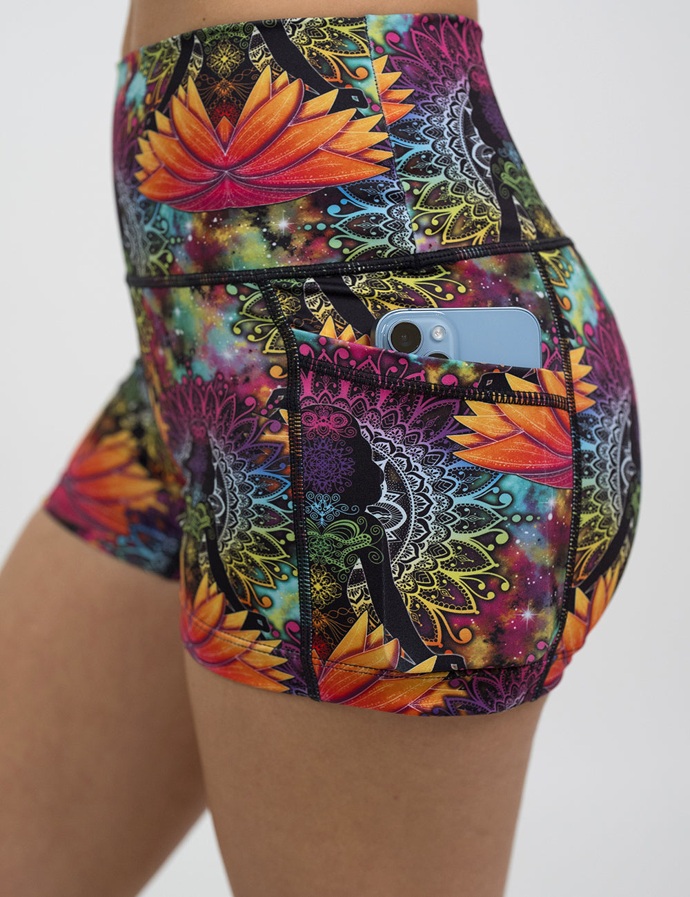 close up of the 2.5 inch colorful yoga lotus flower shorts with a phone in its pocket