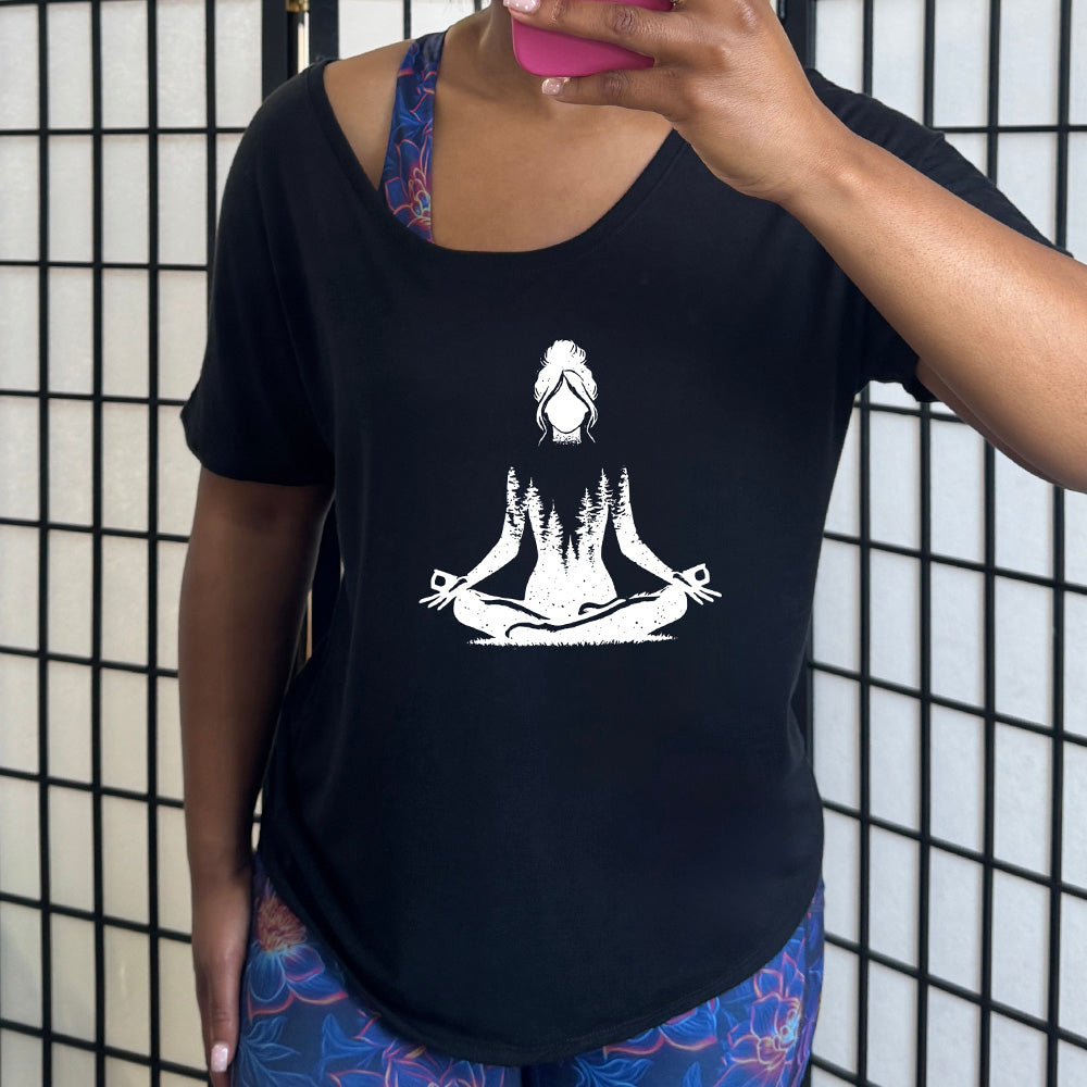 Black slouchy shirt with the graphic of a woman doing a yoga pose, with her shoulders to waist being the silhouette of a forest  