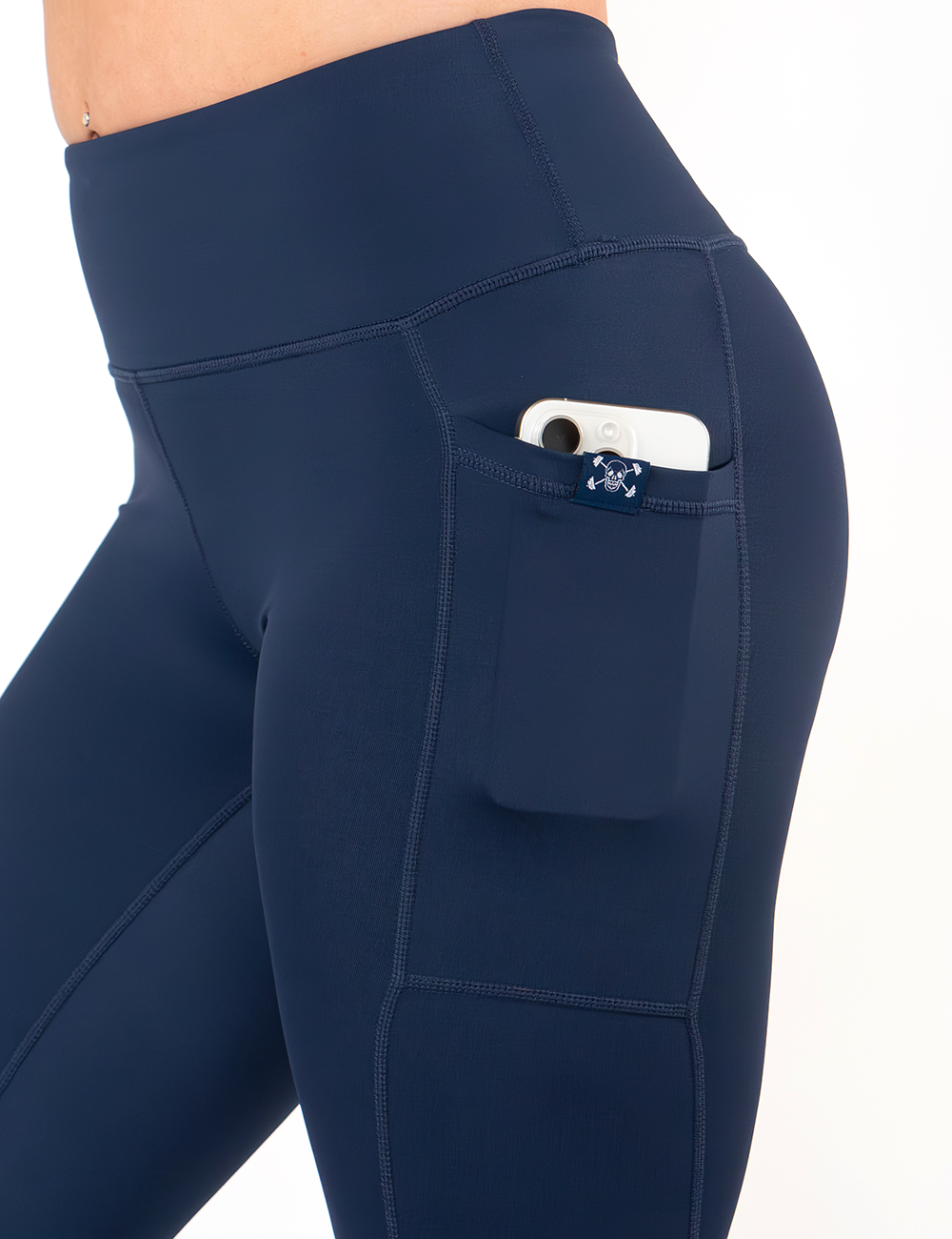 close up of the solid blue navy leggings with a phone in the pocket