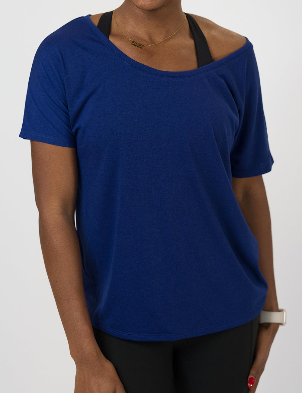 Blue off-shoulder top worn by a person on a white background