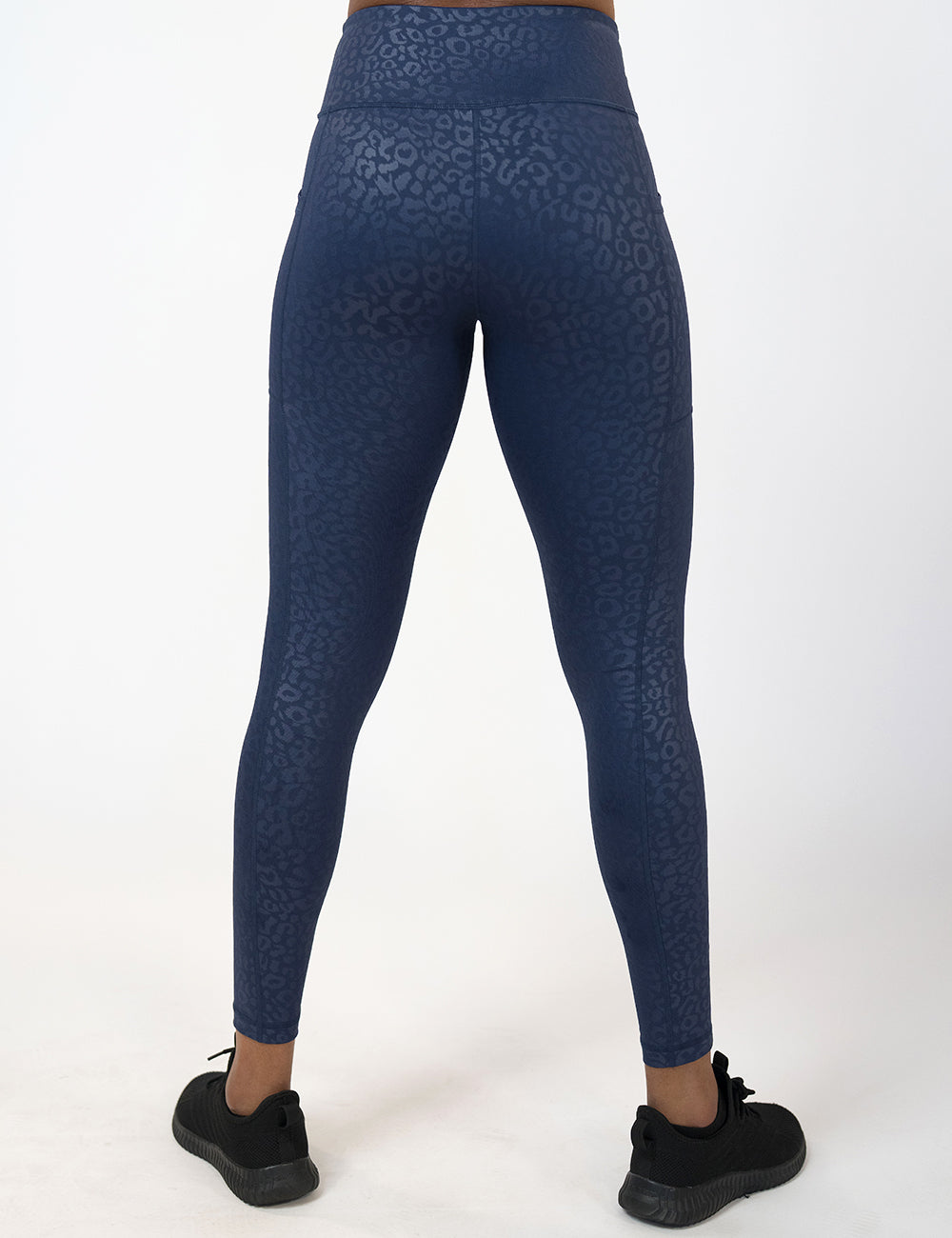 back of the full length dark blue leopard print leggings against a white background