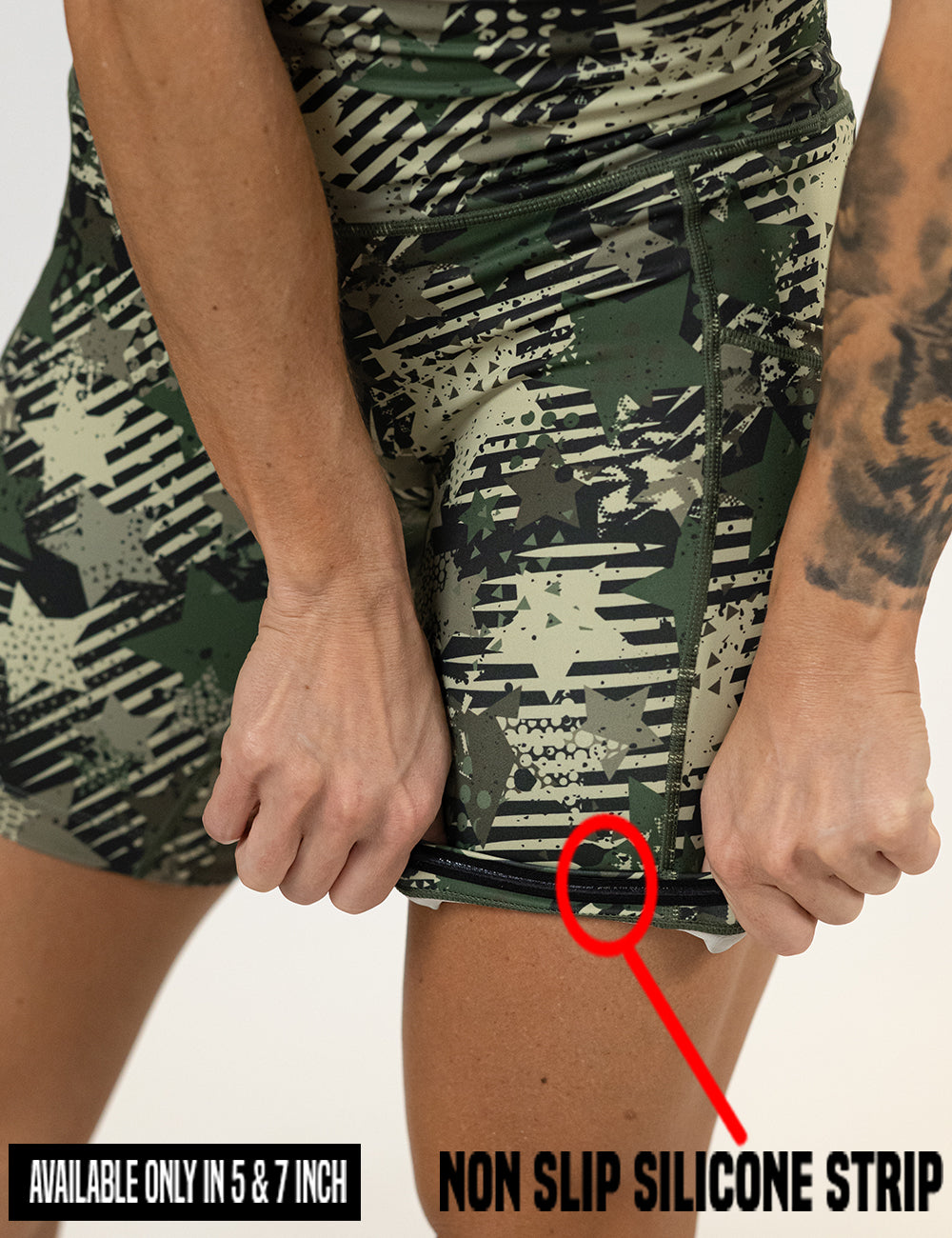 close up of the green camo stars and stripes shorts being rolled up to show the non slip silicone strip found in the 5 and 7 inch inseam lengths