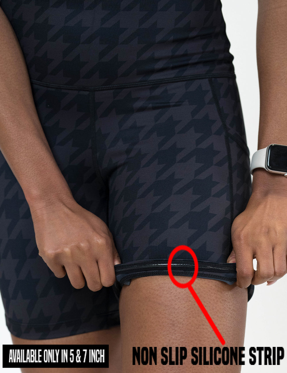 close up of the dark houndstooth pattern shorts being rolled up to show the non slip silicone strip found in the 5 and 7 inch inseam lengths