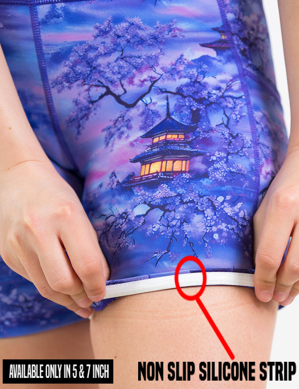 close up of the blue and lavender shorts with traditional pagodas and blooming cherry trees being rolled up to see the non slip silicone strip found in the 5 and 7 inch shorts