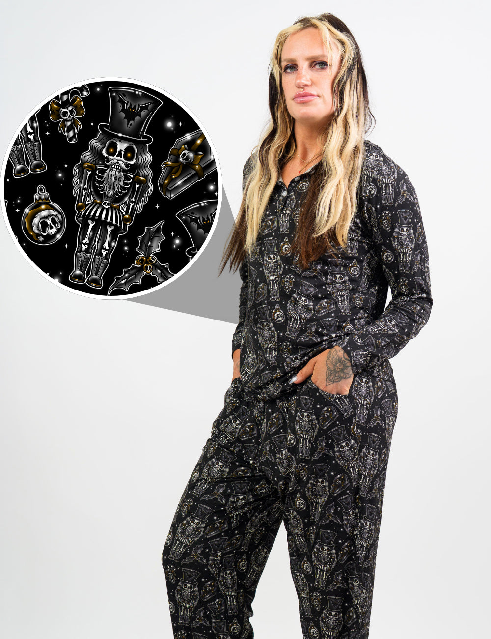 model wearing the black nutcrackers, mistle toe, and Christmas ornaments pajama top and bottoms, with a close up of the print in detail