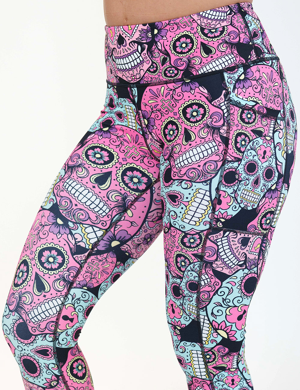 close up of the pink, blue & purple skull print leggings against a white background