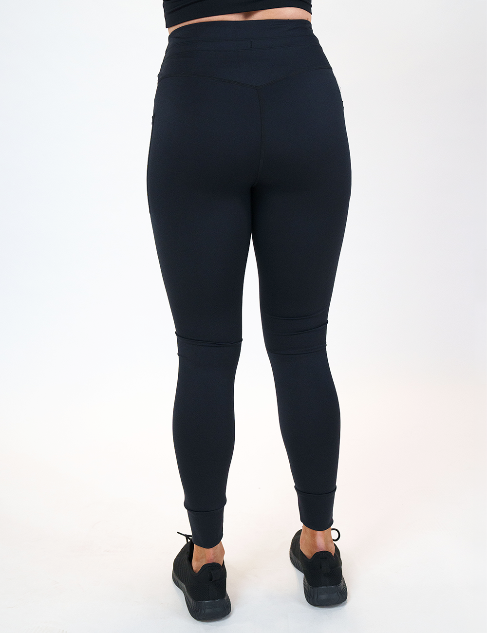 back of the omni black draw string full length leggings against a white background