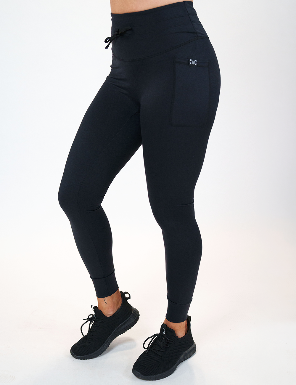model wearing the full length omni black drawstring leggings against a white background