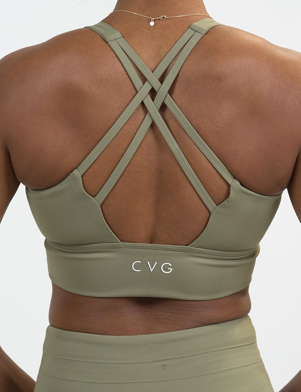back of the omni solid green longline bra against a white background