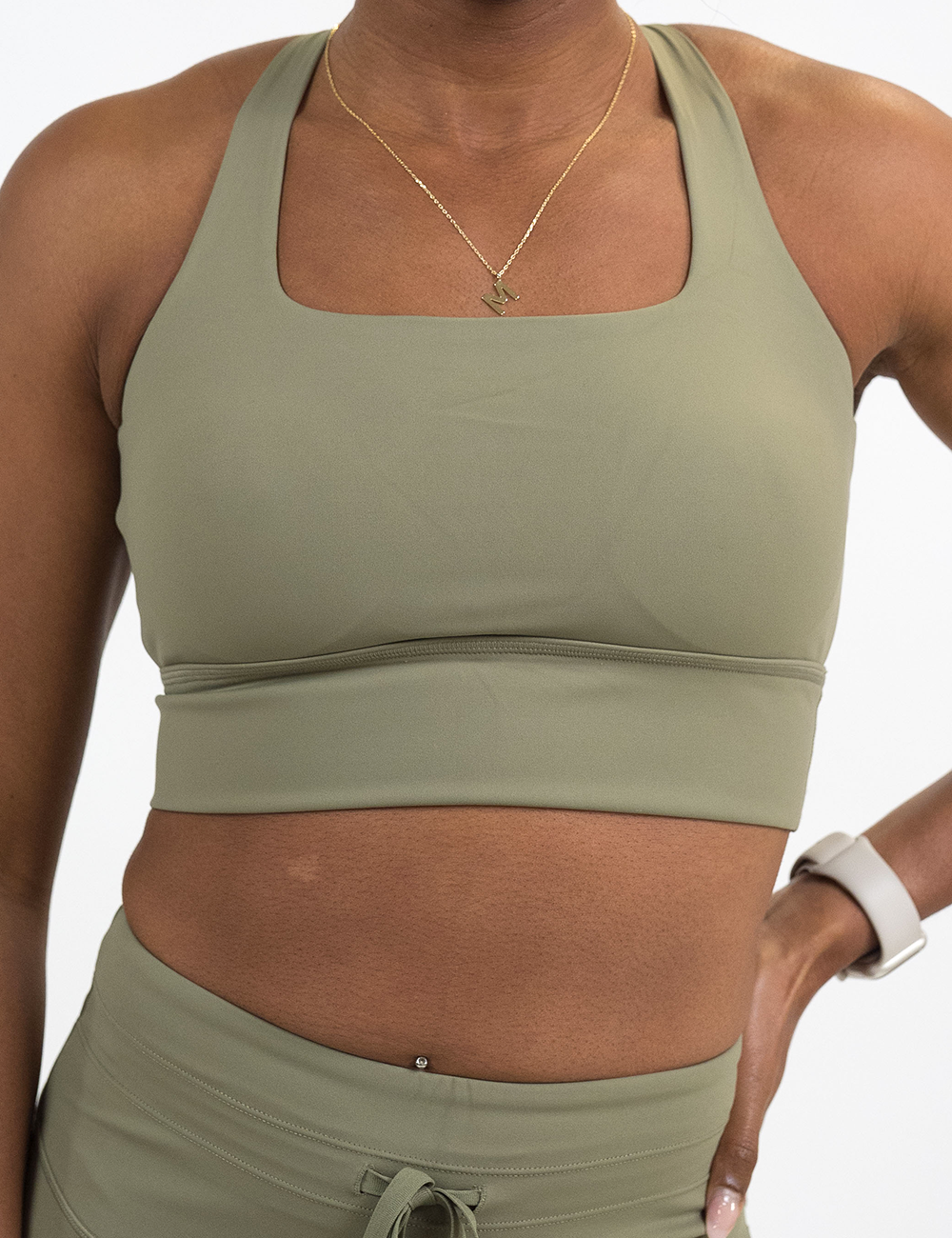front of the omni solid green longline bra against a white background