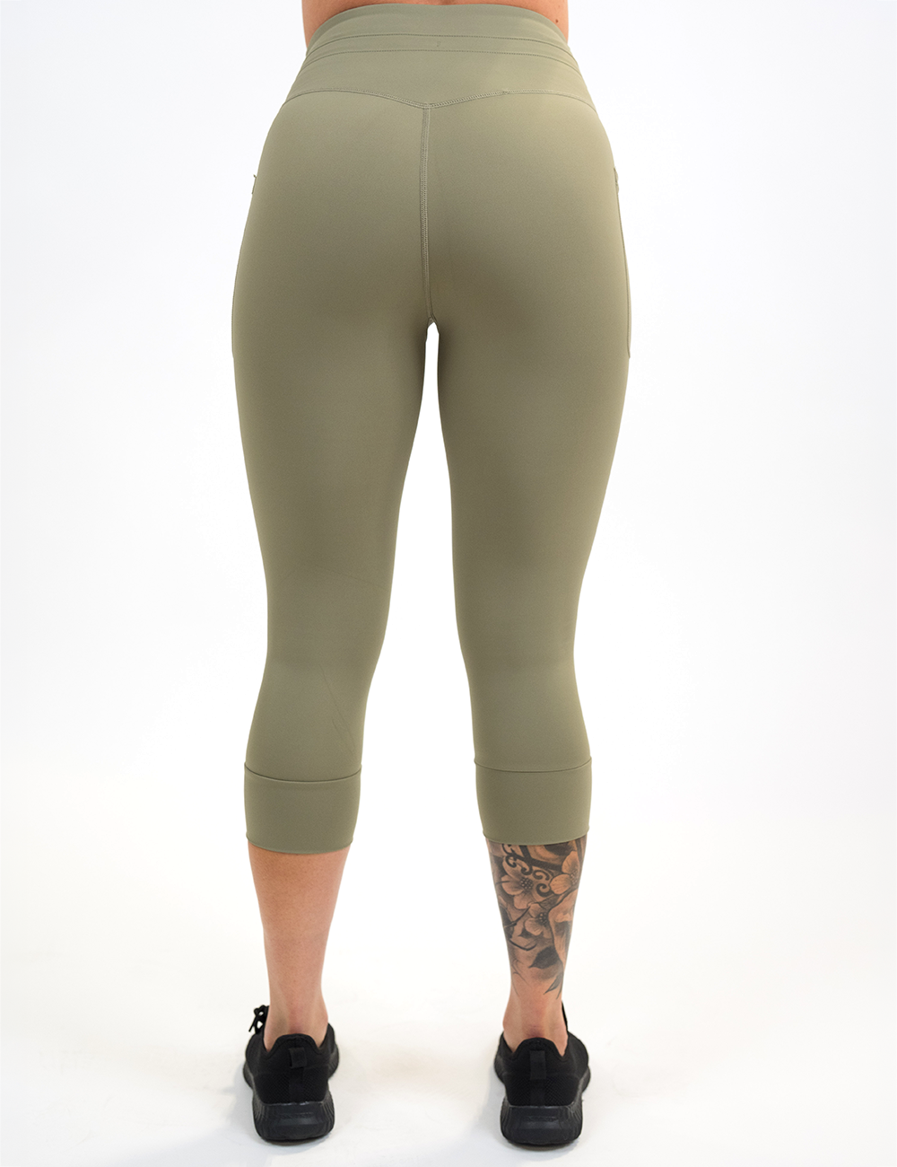 back of the full length omni green tea drawstring leggings against a white background