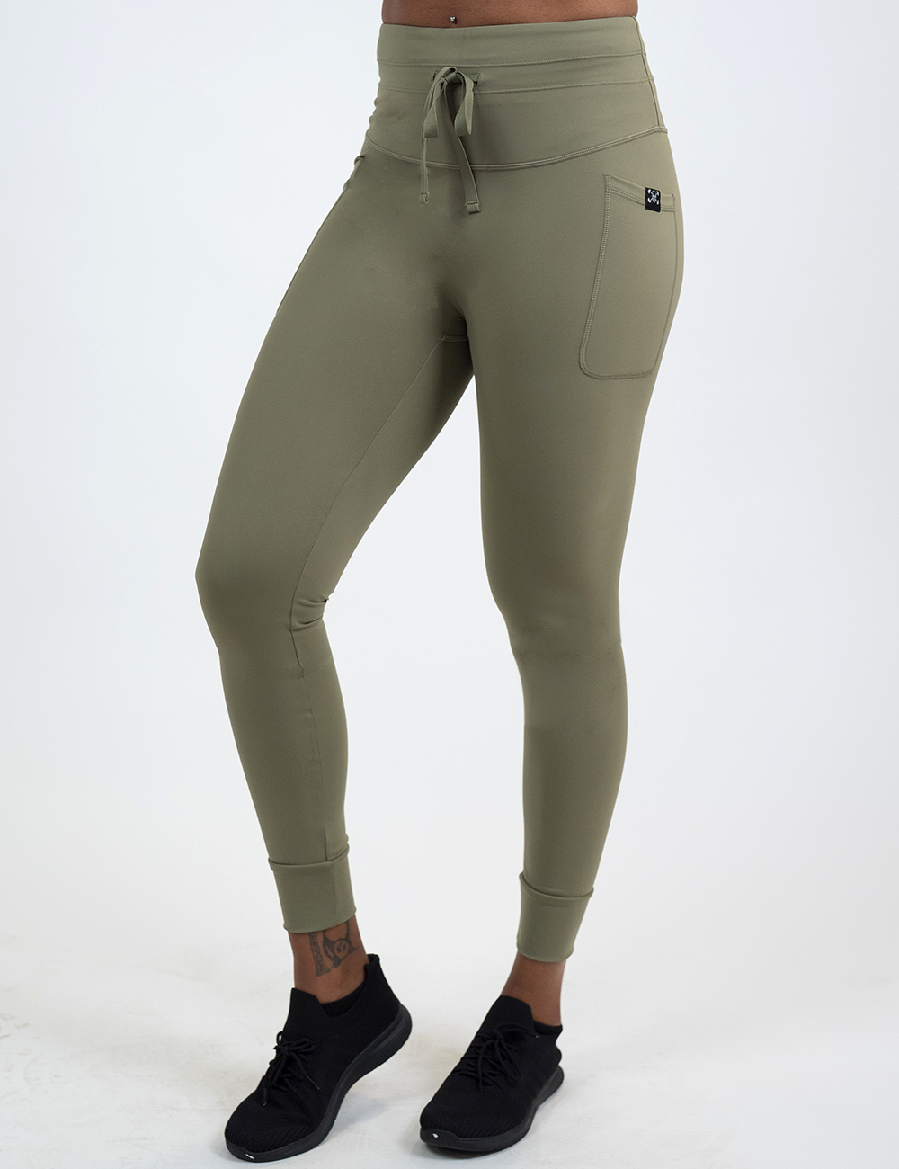 front of the omni green drawstring full length leggings against a white background