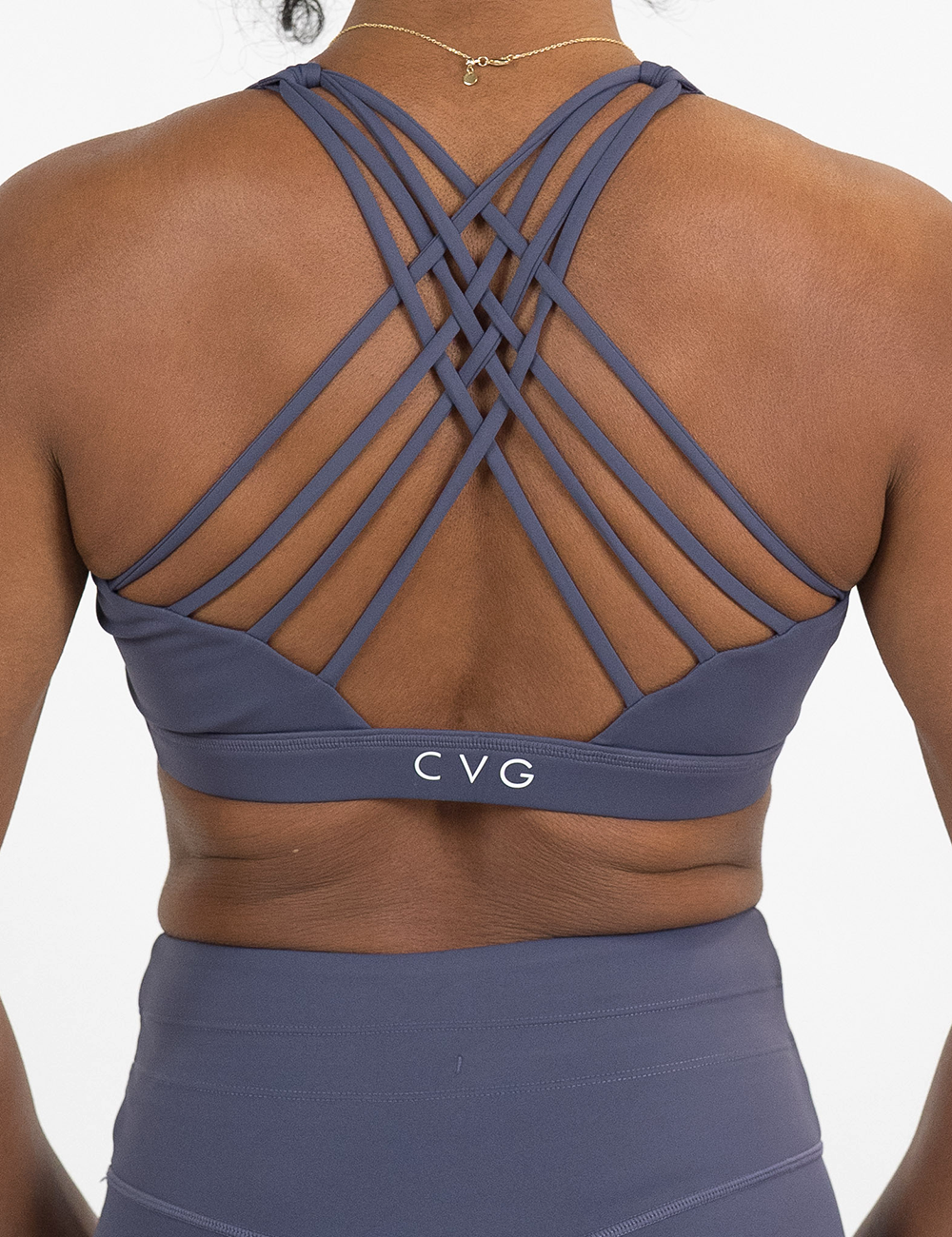 back of the omni solid purple butterfly back bra against a white background