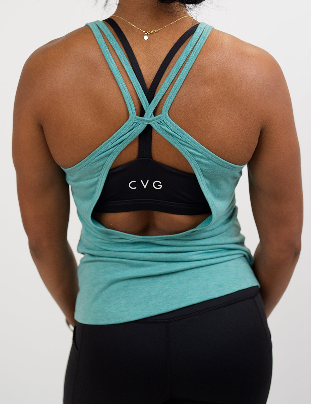 back of the teal open back tank top against a white background