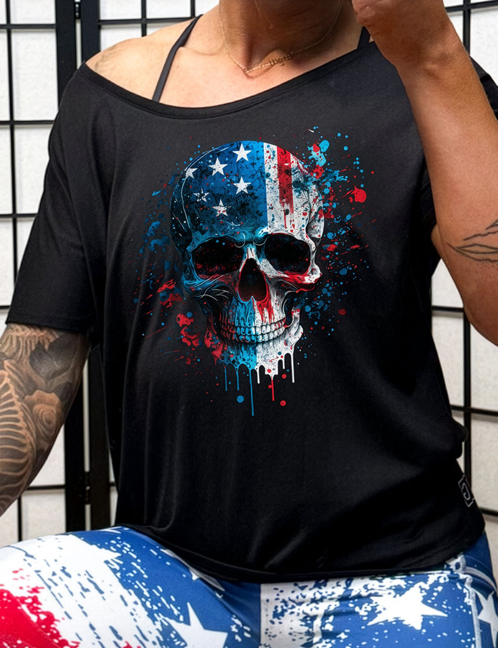 black slouchy tee with a paint splattered american flag skull on it