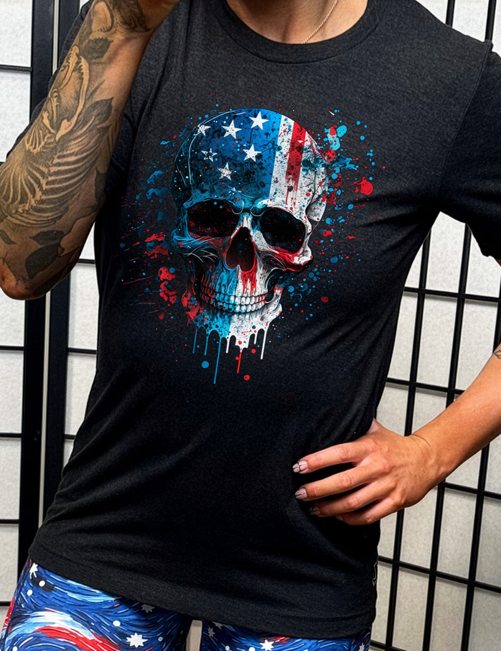 model wearing the Paint Splatter Flag Skull black tee shirt