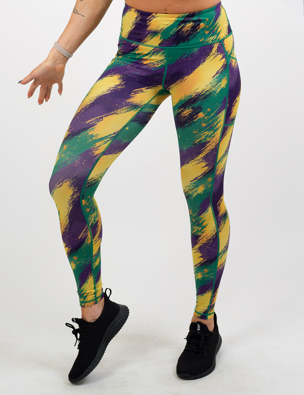 green, yellow. and purple patterned full length leggings facing the front against a white background