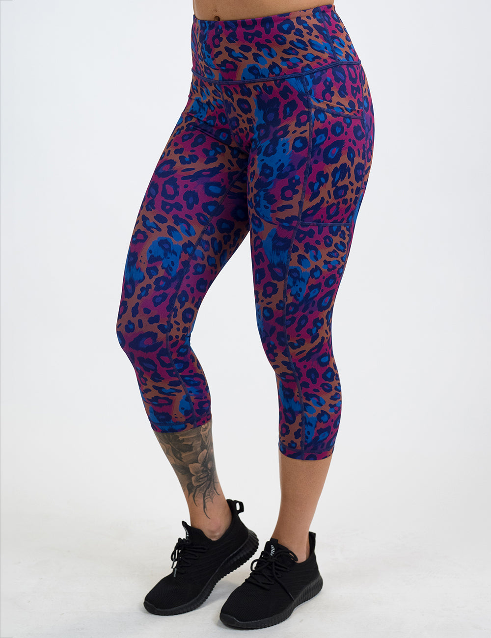 model wearing the capri red, yellow, and blue cheetah print leggings against a white background