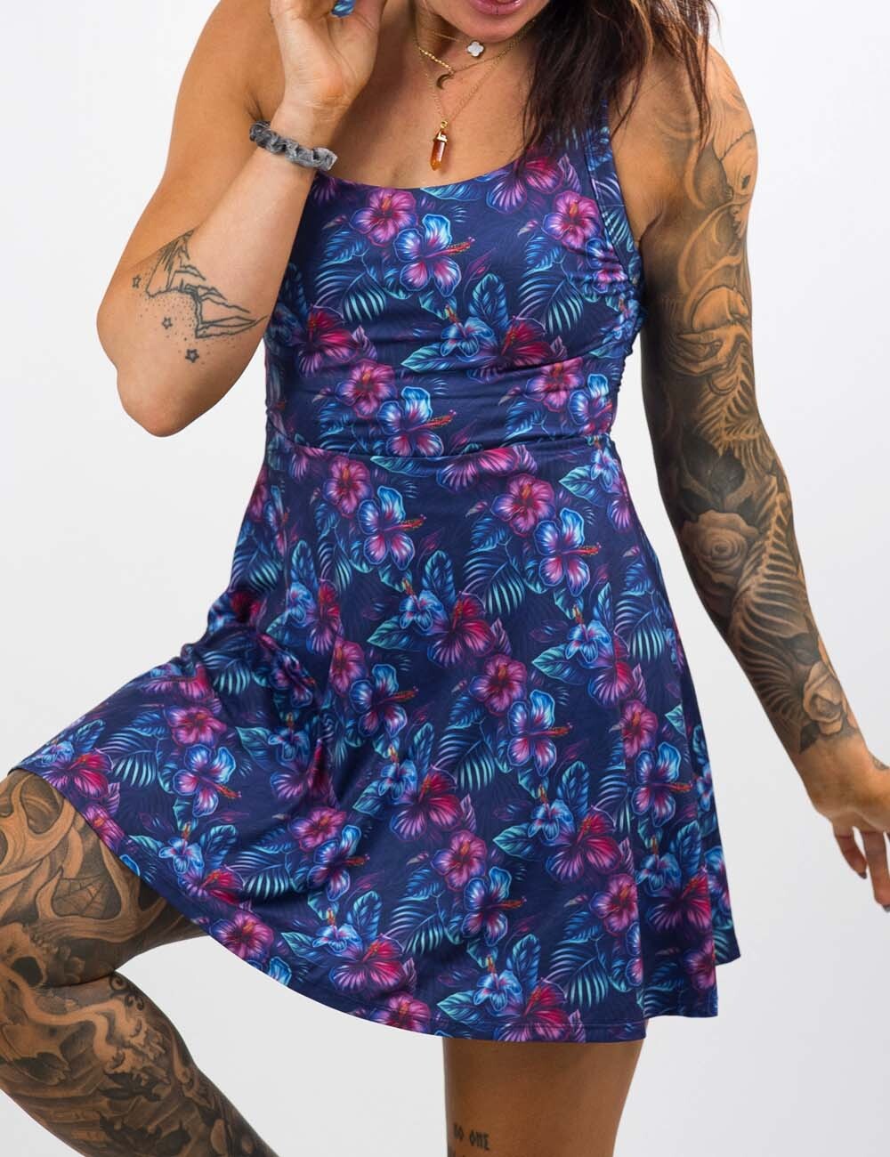 front of the tropical flower themed active dress against a white background