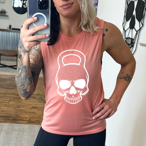 peach muscle tank with a kettlebell skull graphic on the front