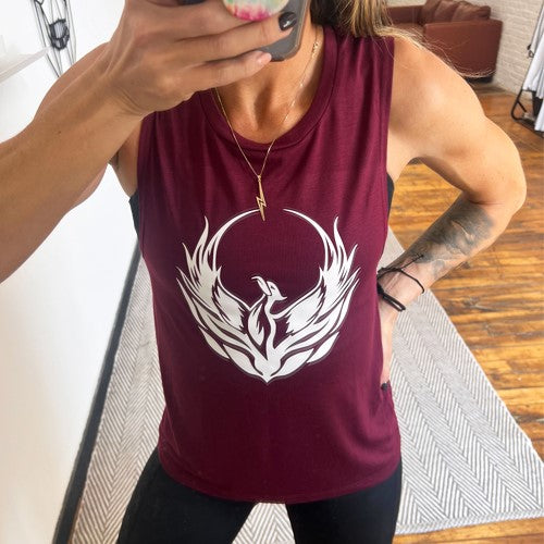 model wearing a maroon muscle tank with a phoenix design on the front