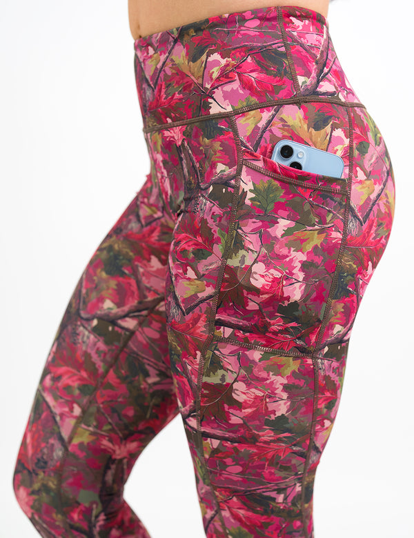 side view of the pink forest camo leggings with a phone in its pocket