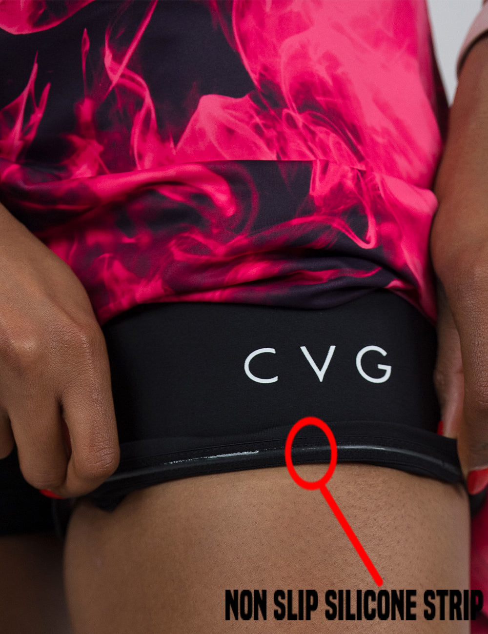close up of the pink smoke patterned shorts being rolled up to show the non slip silicone strip found in the lining of the under shorts
