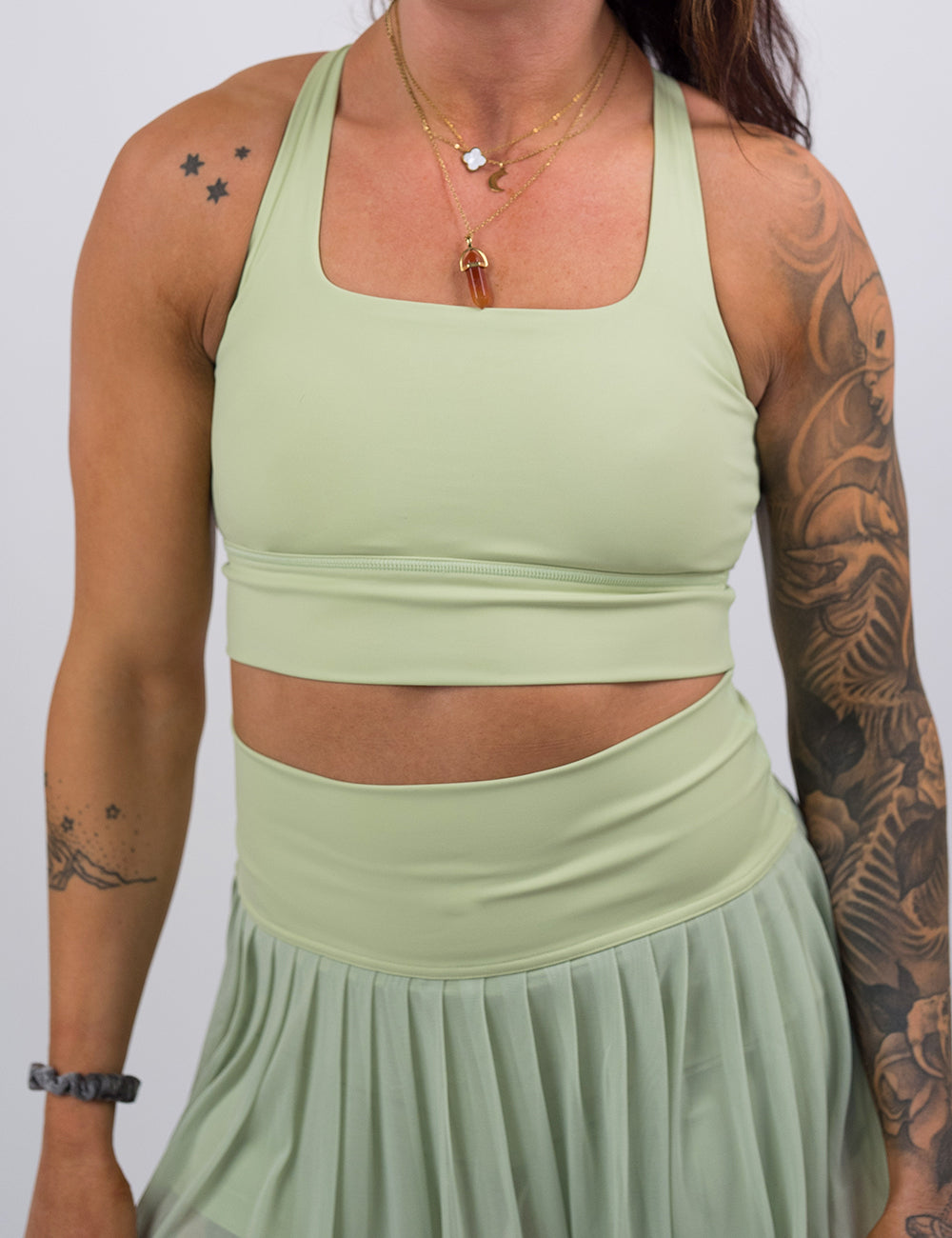 front of the light green longline bra against a white background