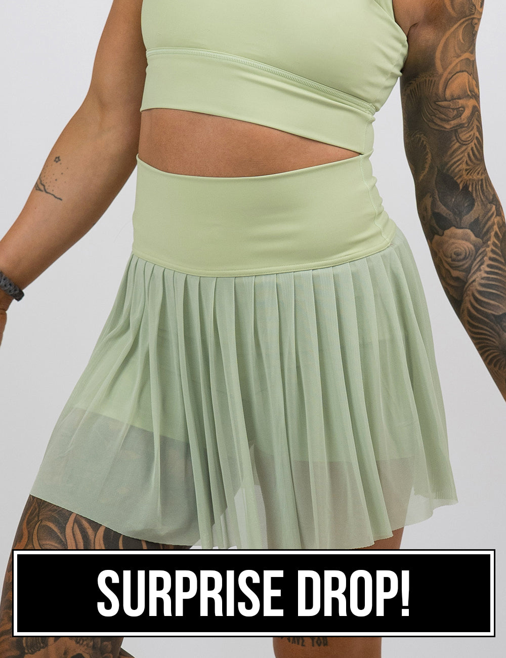front of the light green sheer skirt against a white background, surprise drop